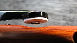 Detail of C-Natural key with white leather pad and metal resonator